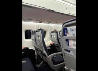 Interior view of a Brussels Airlines cabin showing passengers seated and reading during the flight.