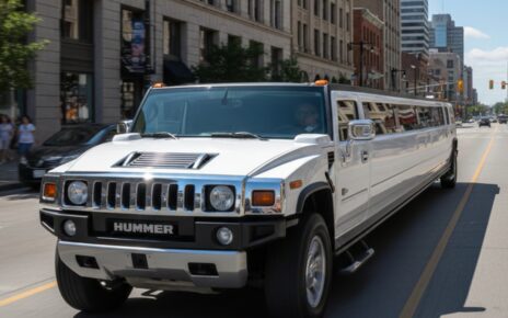 White Hummer stretch limousine driving through the city for AAA VIP Limos.