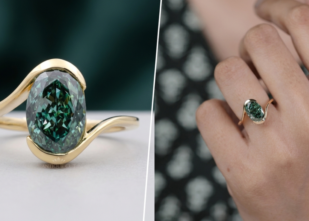 Oval green diamond ring with curved yellow gold band on hand