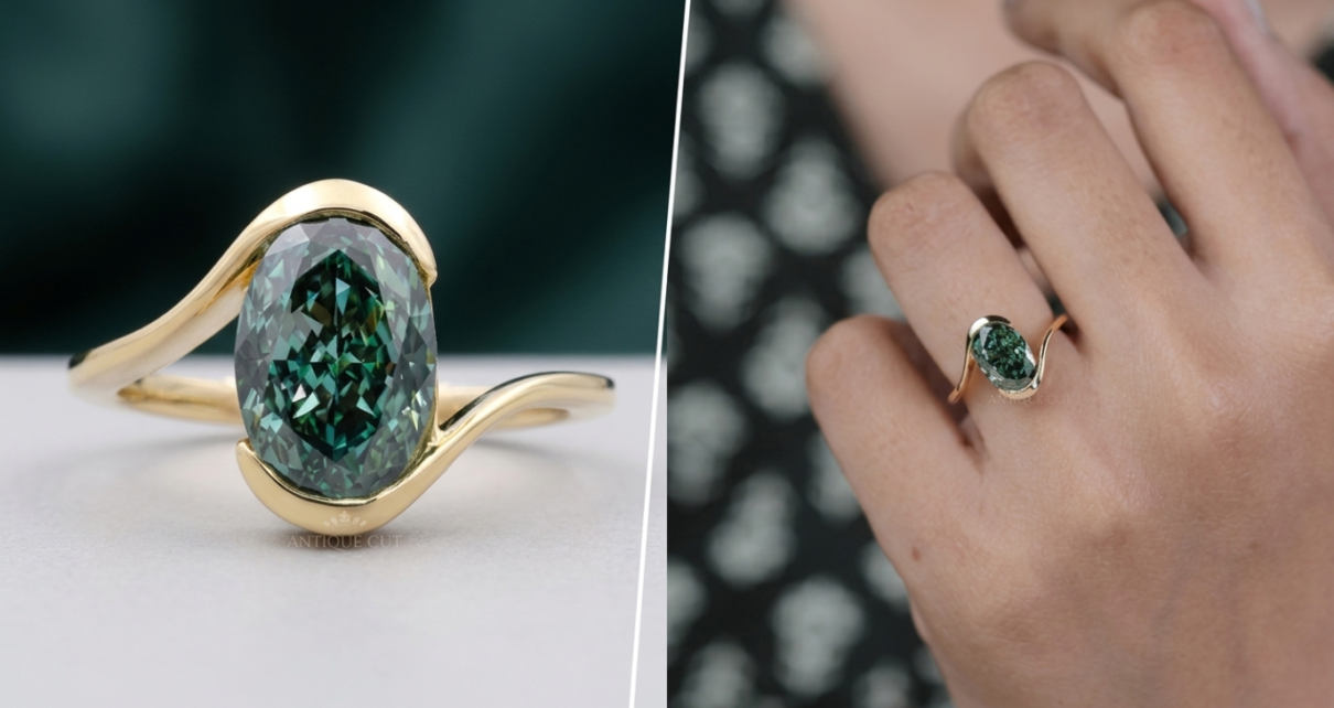 Oval green diamond ring with curved yellow gold band on hand